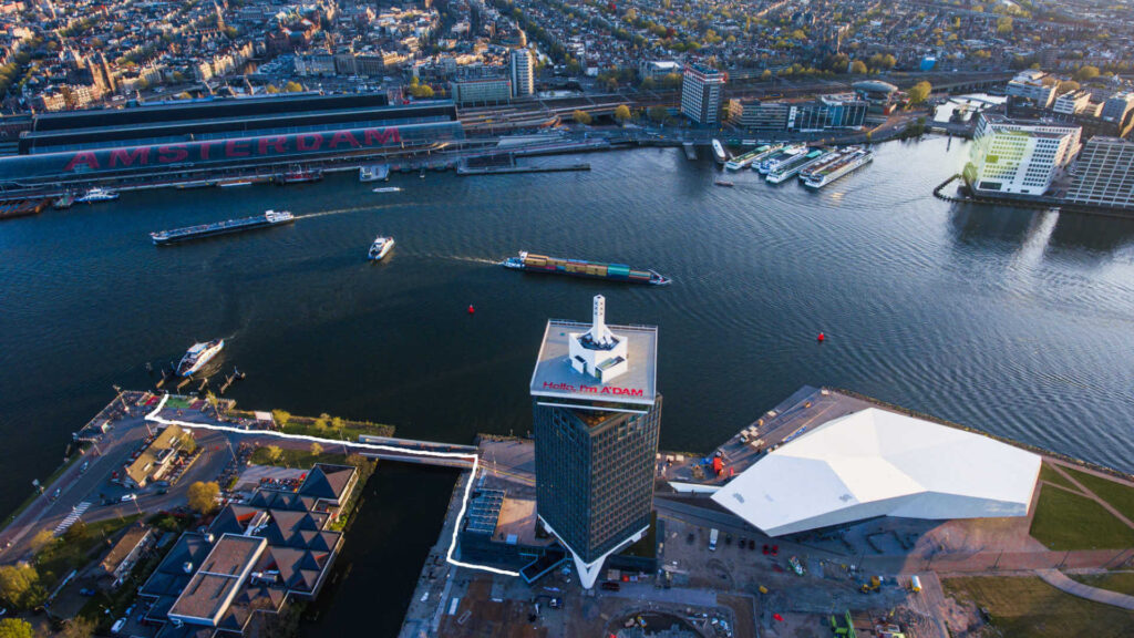 Aerial view of Amsterdam skyline with A’DAM Tower and waterfront, showcasing event location context