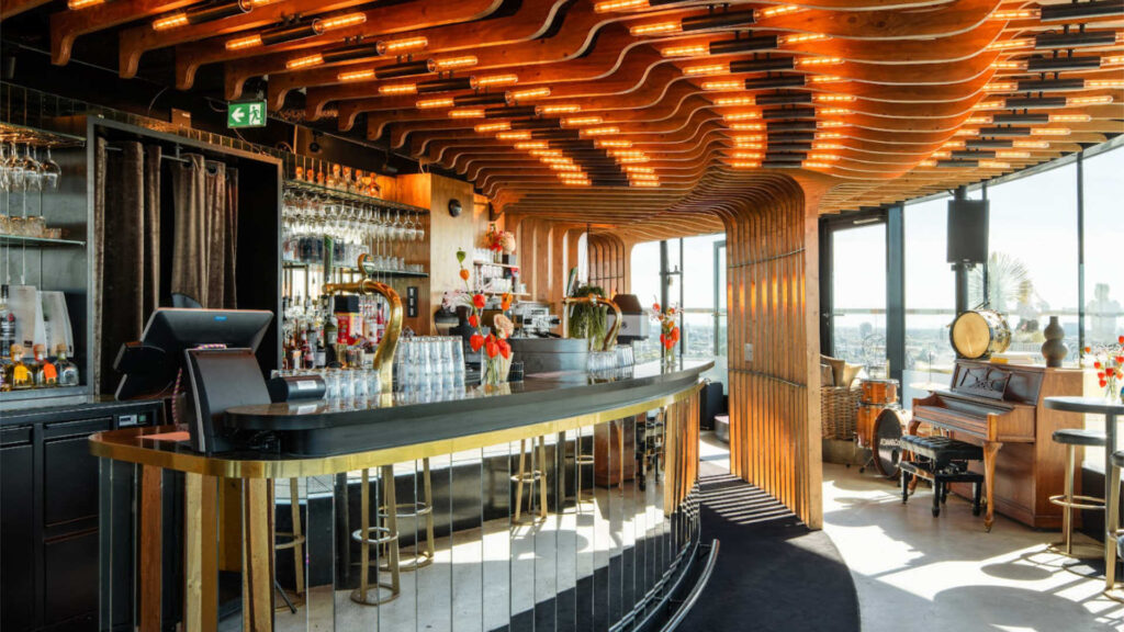 Luxury bar interior with wooden architectural ceiling design and premium cocktail setup