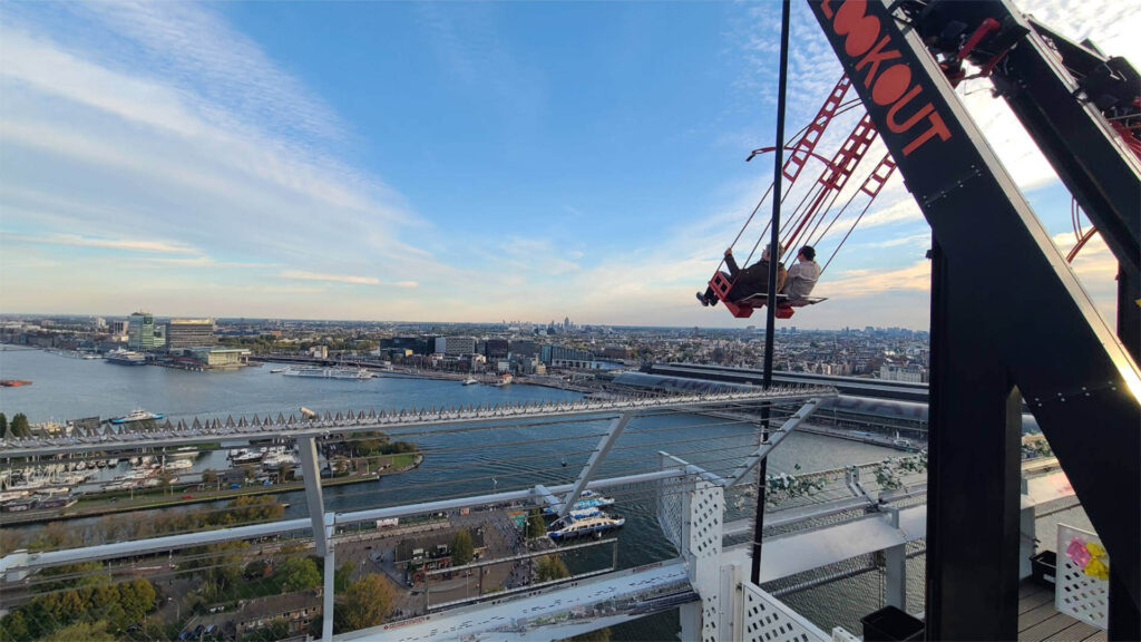 Rooftop swing experience overlooking city skyline, offering unique entertainment at corporate events