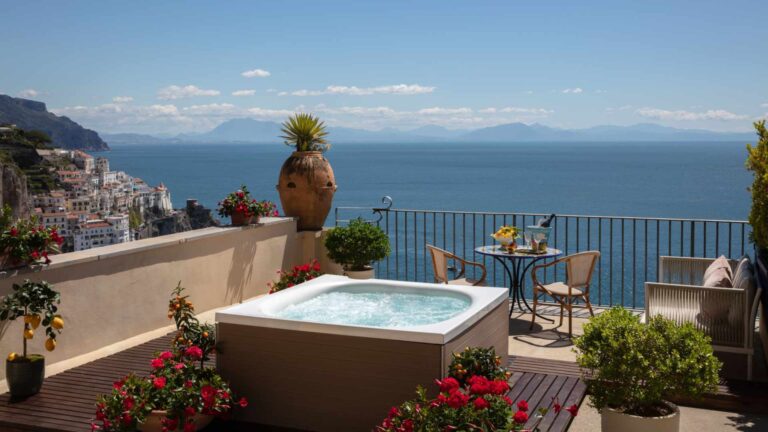 A private sea-view terrace with a jacuzzi at the Anantara Convento di Amalfi Grand Hotel, overlooking the Tyrrhenian Sea and the clifftop town of Amalfi — the standard of accommodation a well-briefed incentive travel agency selects when a destination's character is allowed to shape the guest experience.