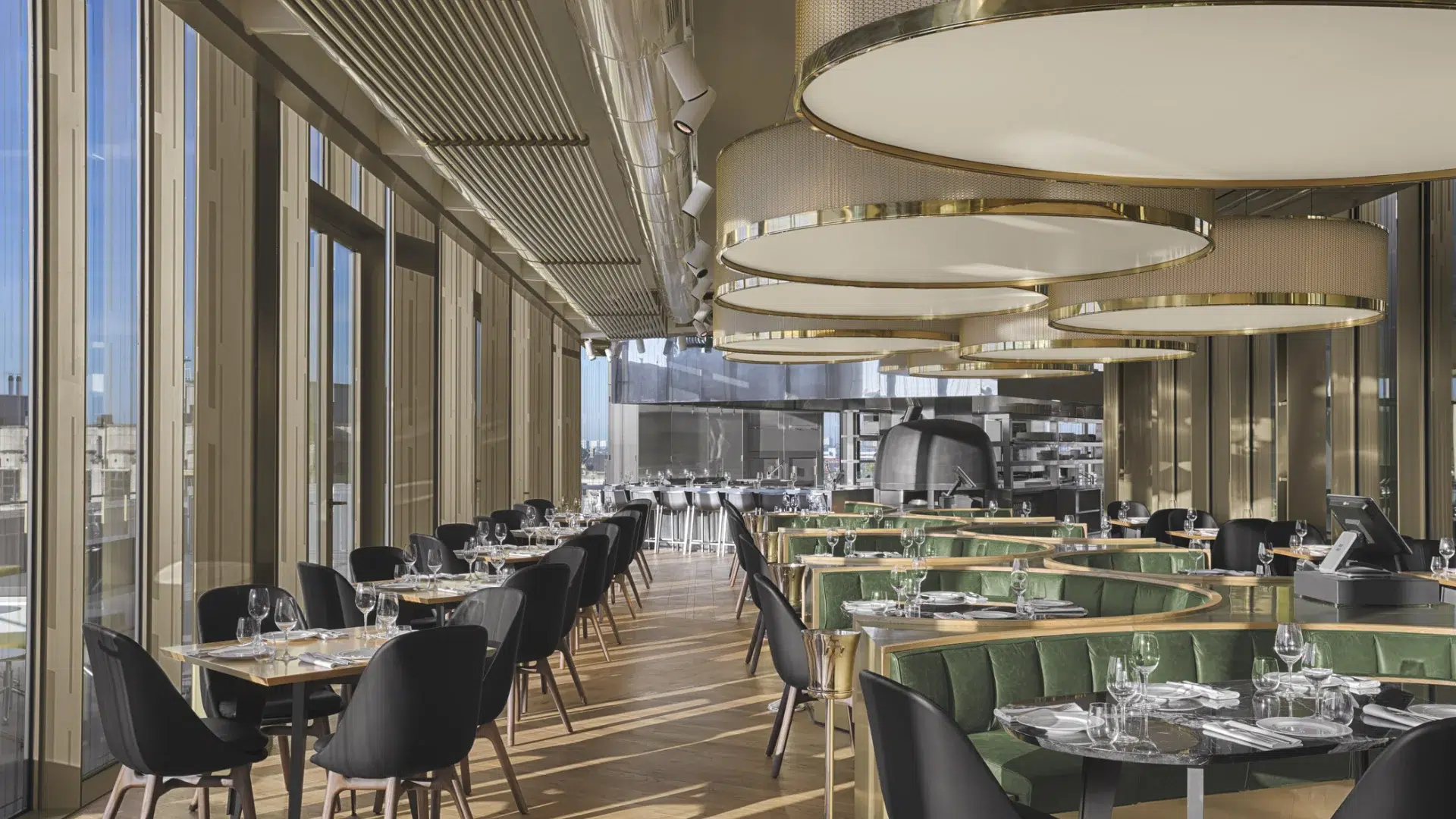 Mr Porter restaurant in Amsterdam with brass pendant lights, green velvet booths and floor-to-ceiling city views, a venue that works equally well for a corporate dinner and an informal team gathering